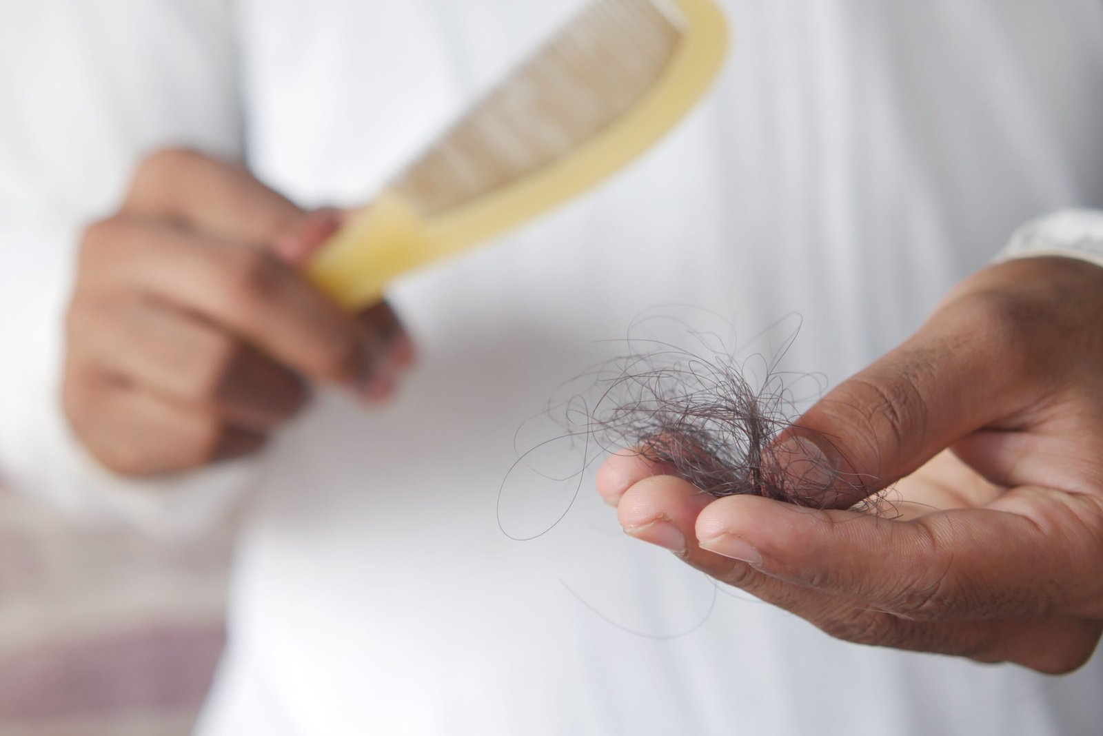 Mulher cuidando dos cabelos, relacionado a queda de cabelo feminina